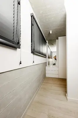 a hallway with white walls and wood floors at Modern and spacious loft type apartment 8 with free private parking by 