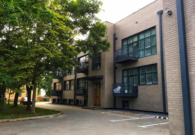 a building with a parking lot in front of it at Modern and spacious loft type apartment 8 with free private parking by 