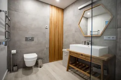 a bathroom with a sink and a toilet and a mirror at Modern and spacious loft type apartment 8 with free private parking by 