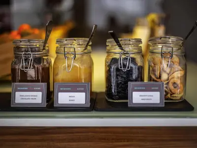 a display of jars of food on a shelf at Ibis Kaunas Centre in Kaunas