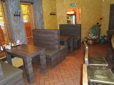 a dining room with two tables and a table and chairs at Geltona in Šiauliai