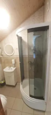 a bathroom with a shower and a toilet and a sink at Geltona in Šiauliai