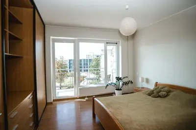 a bedroom with a bed and a large window at New apartament very close to the city centre in Vilnius
