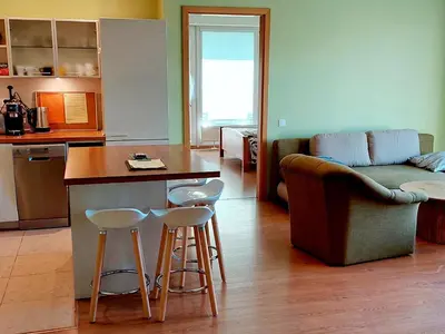 a kitchen with a counter and stools in a room at New apartament very close to the city centre in Vilnius