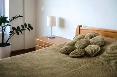 a bedroom with a bed with two pillows on it at New apartament very close to the city centre in Vilnius