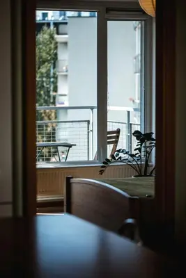 a room with a window and a table with a plant at New apartament very close to the city centre in Vilnius