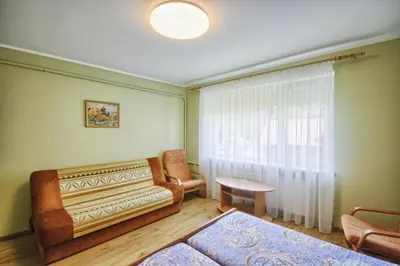 a living room with a couch and a table at Poilsis Pas Tada in Druskininkai