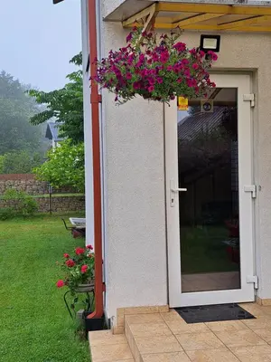 a door to a house with pink flowers on it at Poilsis Pas Tada in Druskininkai