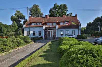a white house with a red roof at Ašmonienės svečių namai 