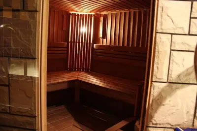 a small wooden sauna with a woodenvisor at Ašmonienės svečių namai 