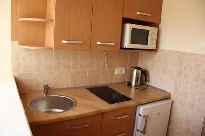 a kitchen with a sink and a microwave at Ašmonienės svečių namai 