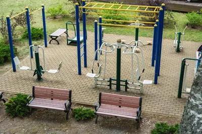 two benches sitting in front of a play park at Senelio Romo Sodyba in Molėtai