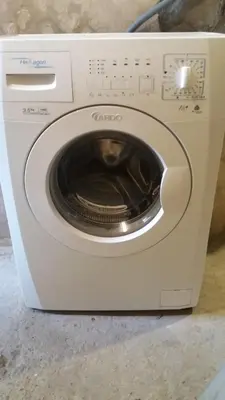 a white washing machine sitting on a counter at Verkių Namelis in Vilnius