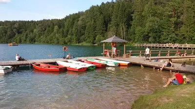 a group of boats parked at a dock on a lake at Verkių Namelis in Vilnius