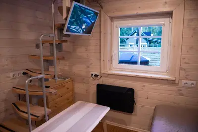 a room with a desk and a tv and a window at Sodyba Namelis medyje Anykščiuose in Anykščiai