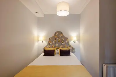 a bed with a headboard in a room at Stepono apartments in Vilnius