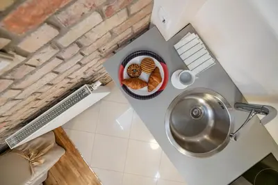 a small kitchen with a sink and a plate of bread at Stepono apartments in Vilnius