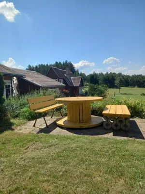 a picnic table and two benches in a yard at Sodyba Dubinga in Molėtai