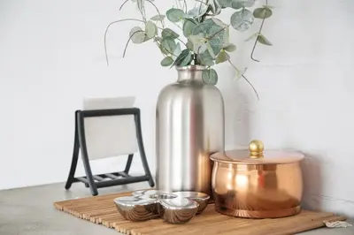 a table with a vase and a tray with candles at The Central Spot in Šiauliai