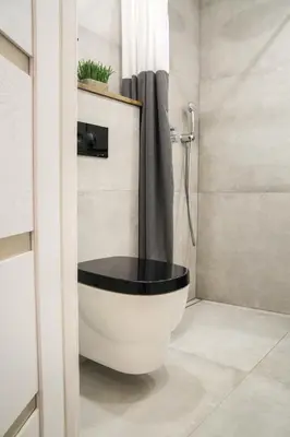 a bathroom with a white tub in a shower at The Central Spot in Šiauliai