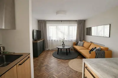 a living room with a couch and a table at The Central Spot in Šiauliai