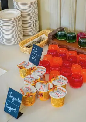 a group of containers of food sitting on a table with plates at Nykščio Namai & SPA in Anykščiai