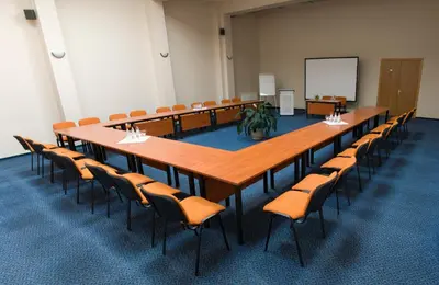 a large conference room with a long table and chairs at Nykščio Namai & SPA in Anykščiai