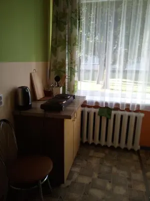 a room with a desk and a window with a radiator at Anykštukas in Anykščiai