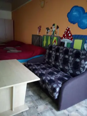 a living room with a couch and a table at Anykštukas in Anykščiai