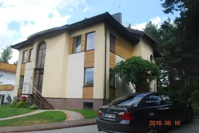 a black car parked in front of a house at Domina in Vilnius