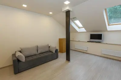 a living room with a couch and a tv at Domina in Vilnius