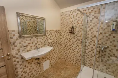 a bathroom with a sink and a shower at Domina in Vilnius