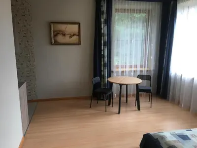 a dining room with a table and chairs in a room at Domina in Vilnius