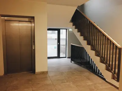 a hallway with a staircase and a door at New apartments for your stay in Vilnius in Vilnius