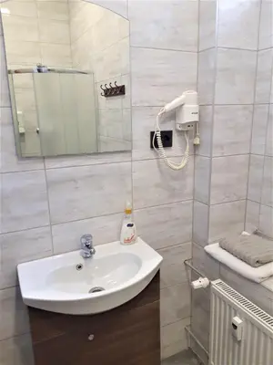 a bathroom with a sink and a mirror at Sweet Apartments in Šiauliai