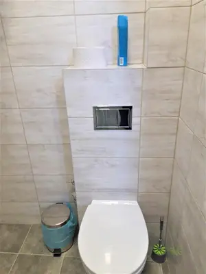 a small bathroom with a toilet in a stall at Sweet Apartments in Šiauliai