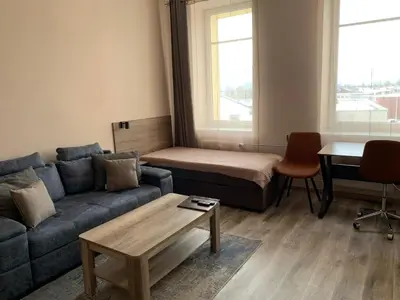 a living room with a couch and a table at Sweet Apartments in Šiauliai