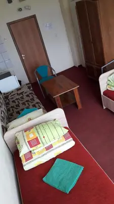 a room with a bed with two books on it at Motelis Jonučiai in Garliava