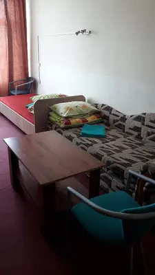 a living room with a couch and a table at Motelis Jonučiai in Garliava