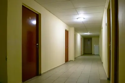 an empty hallway of an office building with a door at Motelis Jonučiai in Garliava