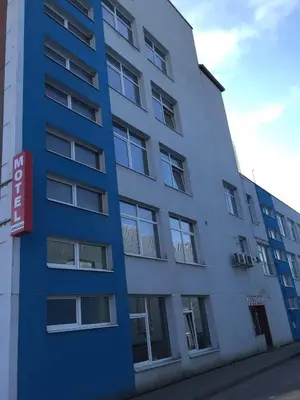 a blue building with a sign in front of it at Motelis Jonučiai in Garliava