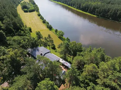 an aerial view of a house next to a river at 