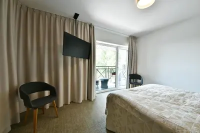 a bedroom with a bed and a chair and a window at 