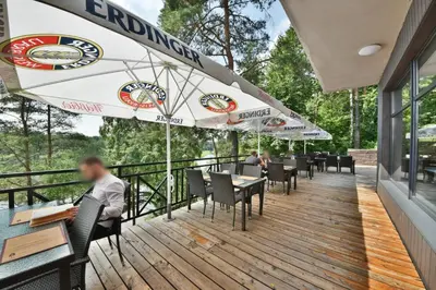 a restaurant with tables and umbrellas on a deck at 