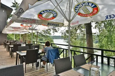 a restaurant with tables and umbrellas on a deck at 
