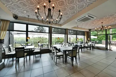 a dining room with tables and chairs and a chandelier at 