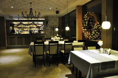 a restaurant with tables and chairs and a bar at 