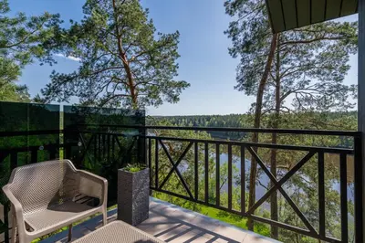 a balcony with a view of a river and trees at 