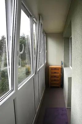 a hallway with a door and a dresser and a window at Relax Inn Druskininkai in Druskininkai