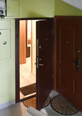 an open door with a mirror in a room at Relax Inn Druskininkai in Druskininkai